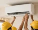 Men installing AC unit